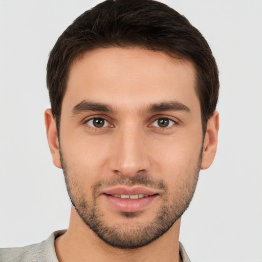 Joyful white young-adult male with short  brown hair and brown eyes