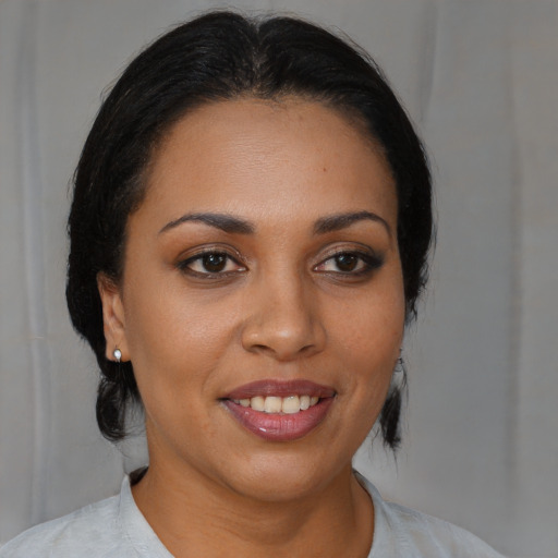 Joyful black young-adult female with medium  brown hair and brown eyes