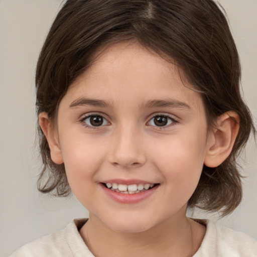 Joyful white child female with medium  brown hair and brown eyes