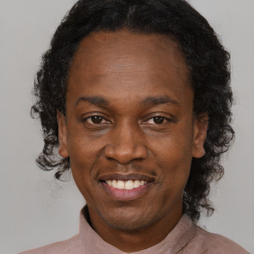 Joyful black adult female with medium  brown hair and brown eyes