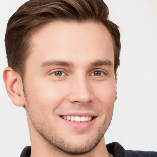 Joyful white young-adult male with short  brown hair and grey eyes