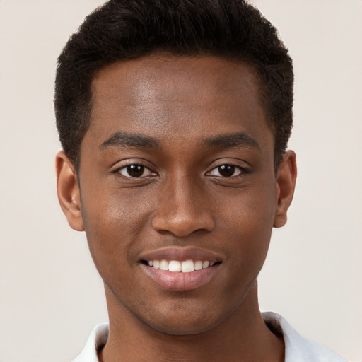 Joyful black young-adult male with short  brown hair and brown eyes