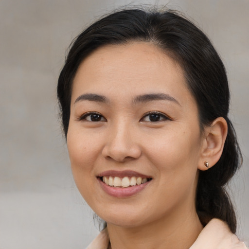 Joyful asian young-adult female with medium  brown hair and brown eyes