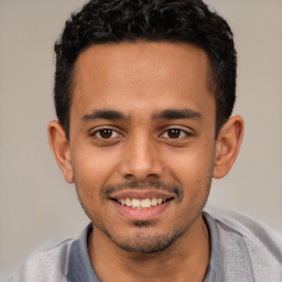 Joyful white young-adult male with short  black hair and brown eyes