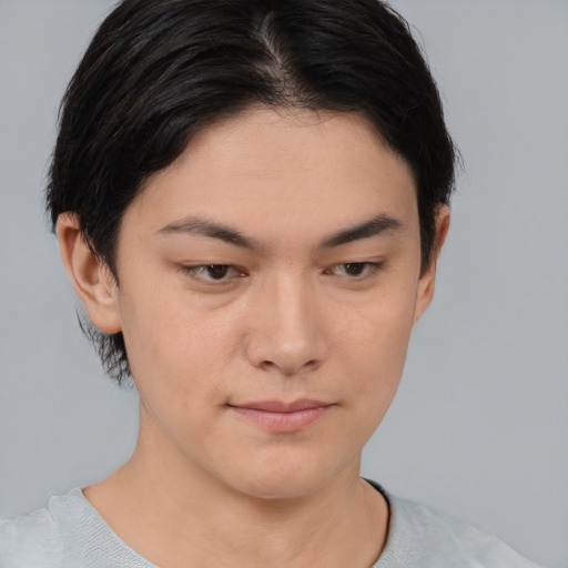 Joyful asian young-adult female with short  brown hair and brown eyes