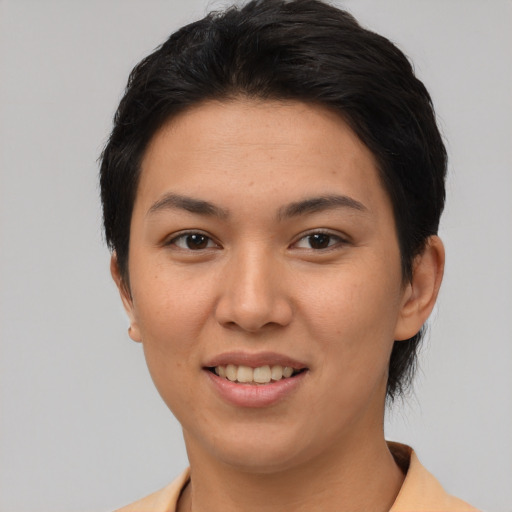 Joyful asian young-adult female with short  black hair and brown eyes