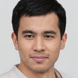 Joyful asian young-adult male with short  black hair and brown eyes