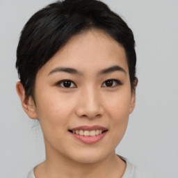 Joyful asian young-adult female with short  brown hair and brown eyes