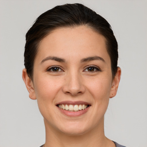 Joyful white young-adult female with short  brown hair and brown eyes