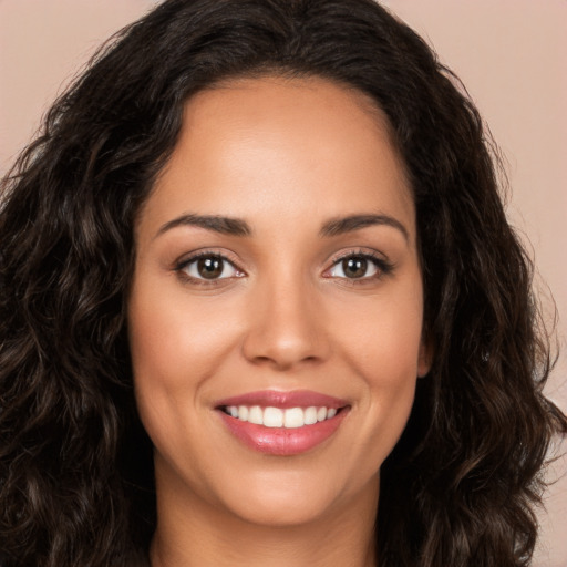 Joyful white young-adult female with long  brown hair and brown eyes