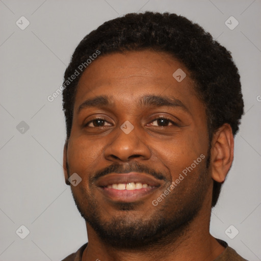 Joyful black young-adult male with short  brown hair and brown eyes