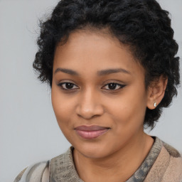 Joyful latino young-adult female with short  black hair and brown eyes