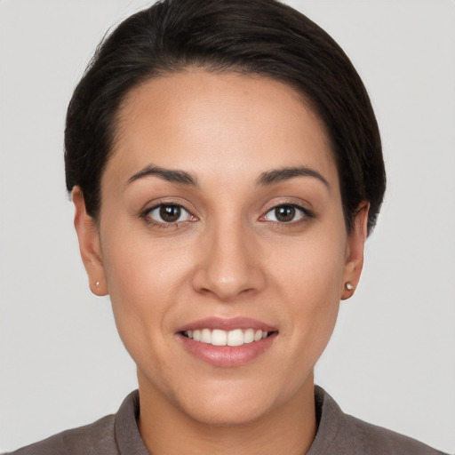 Joyful white young-adult female with short  brown hair and brown eyes