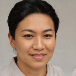 Joyful asian young-adult female with short  brown hair and brown eyes