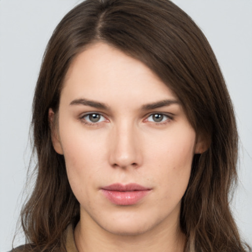 Neutral white young-adult female with long  brown hair and brown eyes