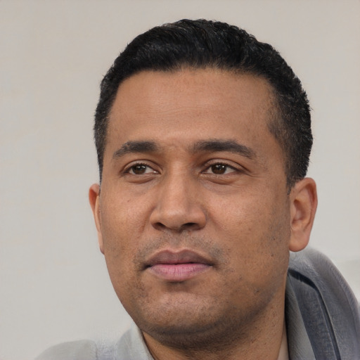 Neutral latino adult male with short  black hair and brown eyes