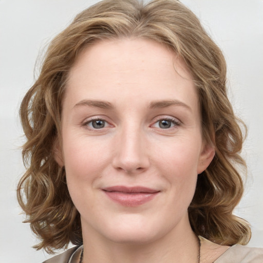 Joyful white young-adult female with medium  brown hair and blue eyes