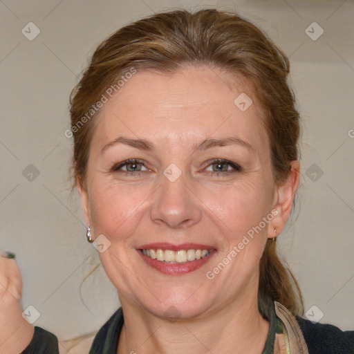 Joyful white adult female with medium  brown hair and blue eyes