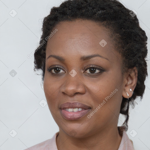 Joyful black young-adult female with long  brown hair and brown eyes