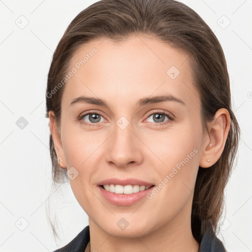 Joyful white young-adult female with medium  brown hair and grey eyes