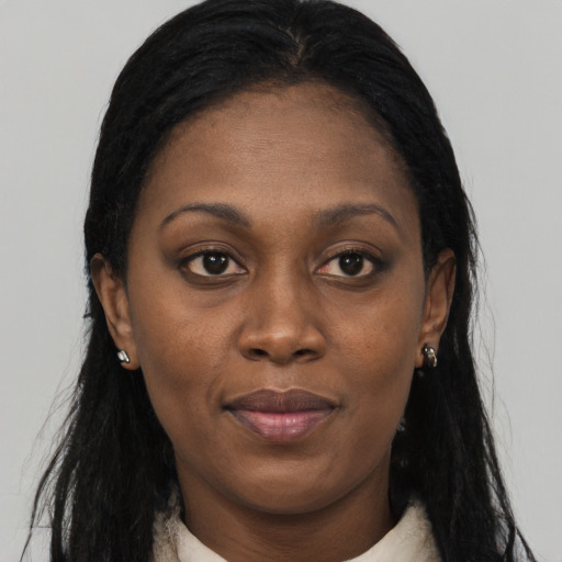 Joyful black young-adult female with long  black hair and brown eyes