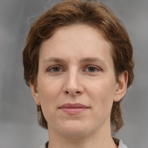 Joyful white adult female with medium  brown hair and grey eyes