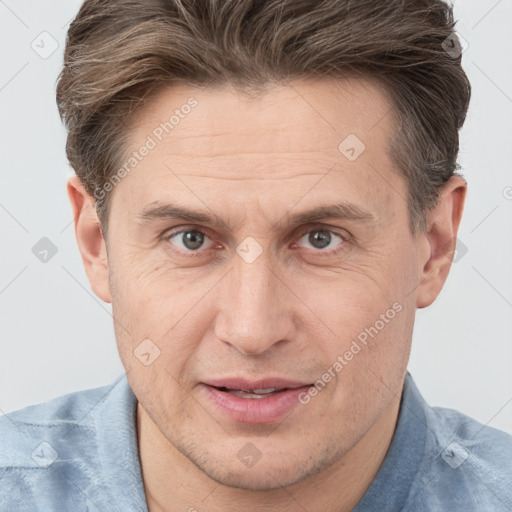 Joyful white adult male with short  brown hair and brown eyes