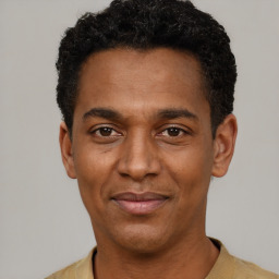 Joyful black adult male with short  black hair and brown eyes