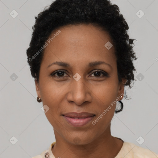 Joyful black adult female with short  black hair and brown eyes