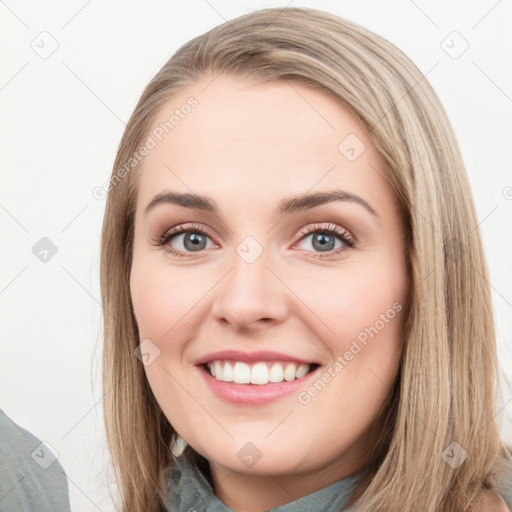 Joyful white young-adult female with long  brown hair and blue eyes