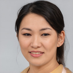 Joyful asian young-adult female with medium  brown hair and brown eyes