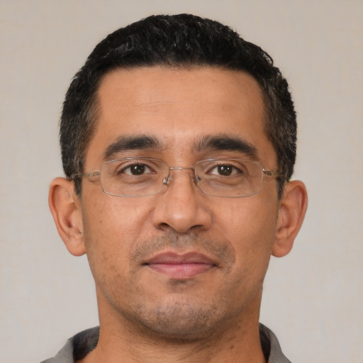 Neutral latino adult male with short  black hair and brown eyes