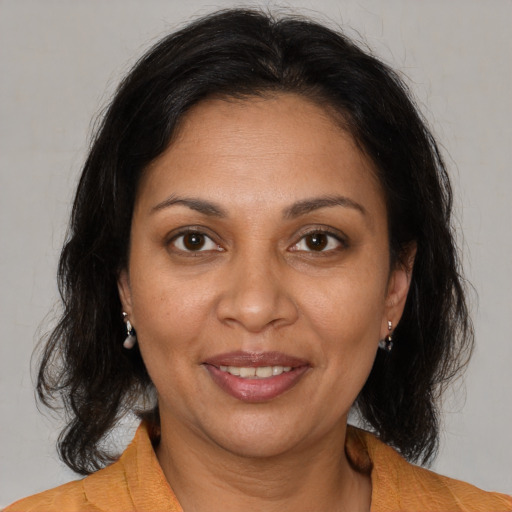 Joyful black adult female with medium  brown hair and brown eyes