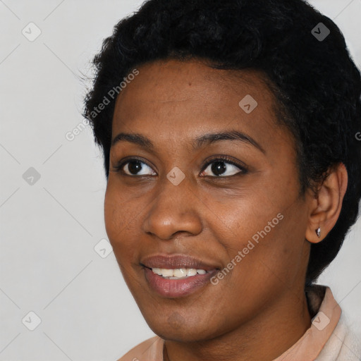 Joyful black young-adult female with short  black hair and brown eyes