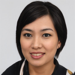 Joyful asian young-adult female with medium  black hair and brown eyes