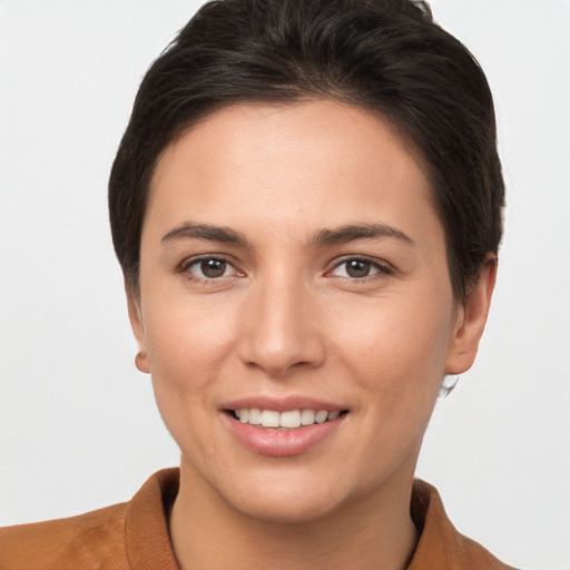 Joyful white young-adult female with short  brown hair and brown eyes