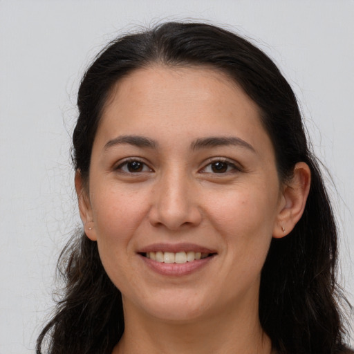 Joyful white young-adult female with long  brown hair and brown eyes