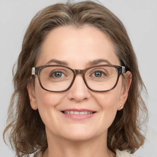 Joyful white adult female with medium  brown hair and blue eyes