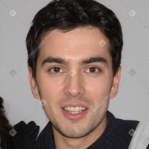 Joyful white young-adult male with short  black hair and brown eyes