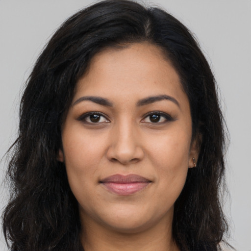 Joyful latino young-adult female with long  brown hair and brown eyes