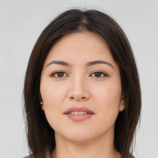 Joyful asian young-adult female with long  brown hair and brown eyes