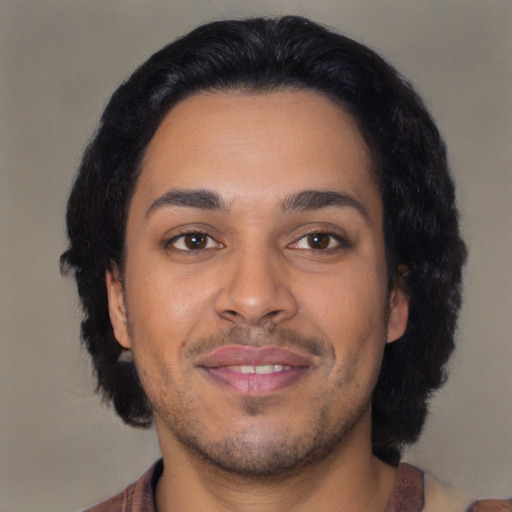 Joyful latino young-adult male with short  brown hair and brown eyes