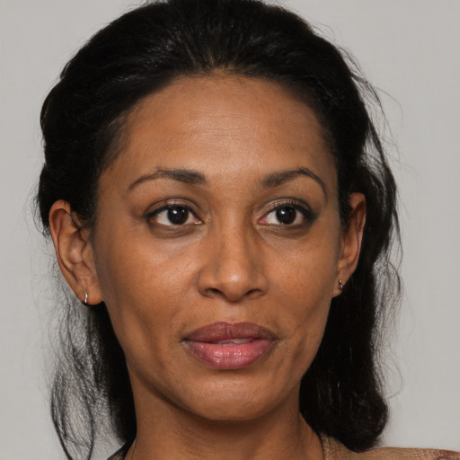Joyful black adult female with medium  brown hair and brown eyes