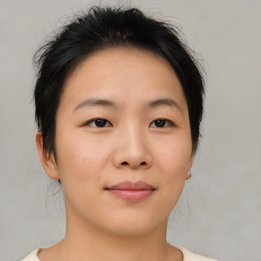 Joyful asian young-adult female with medium  brown hair and brown eyes