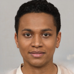 Joyful black young-adult male with short  brown hair and brown eyes