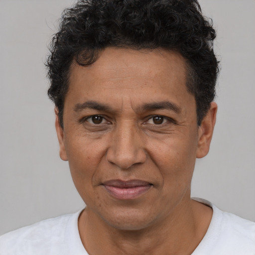 Joyful white adult male with short  black hair and brown eyes