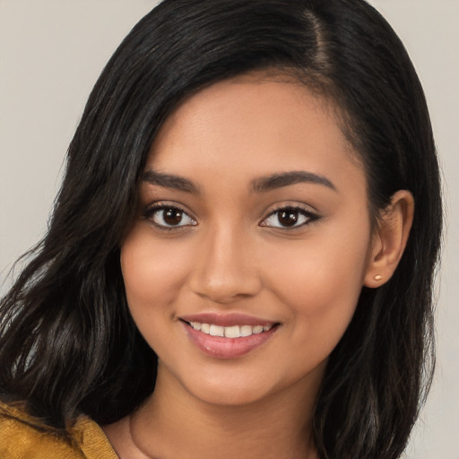 Joyful latino young-adult female with long  brown hair and brown eyes