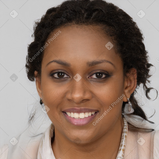 Joyful black young-adult female with long  brown hair and brown eyes