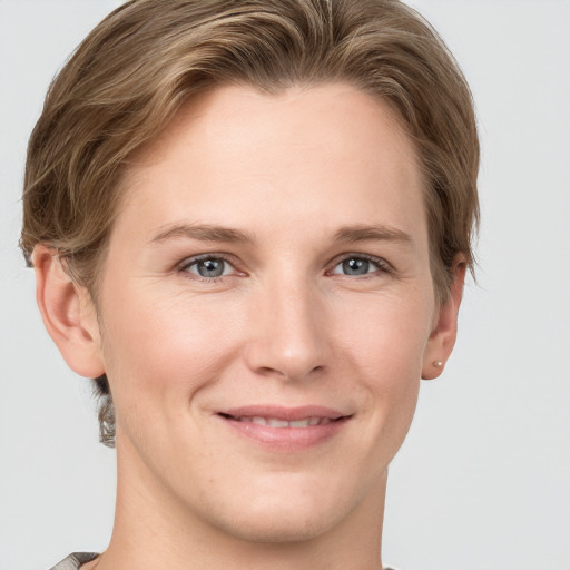 Joyful white young-adult female with short  brown hair and grey eyes