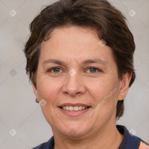 Joyful white adult female with short  brown hair and grey eyes